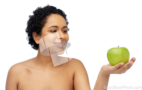 Image of happy african american woman holding green apple