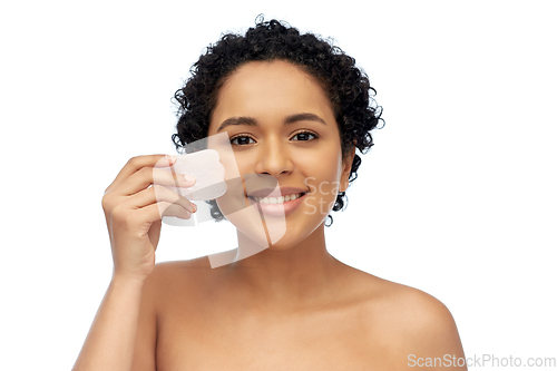 Image of happy woman massaging her face with gua sha tool