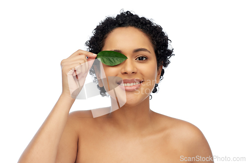 Image of portrait of african american woman with green leaf