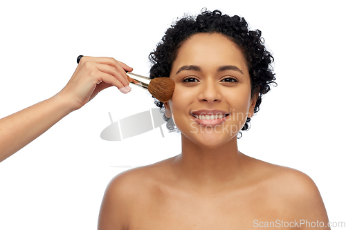 Image of happy woman and hand of make up artist with brush