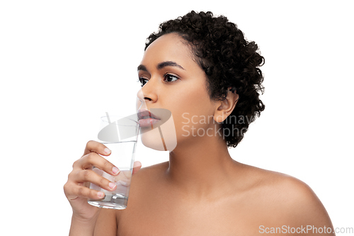 Image of young african american woman with glass of water