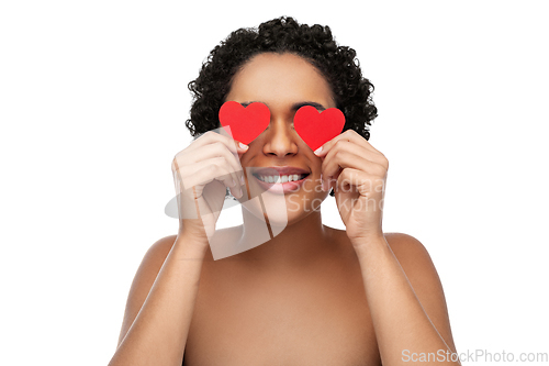 Image of african american woman covering eyes with hearts