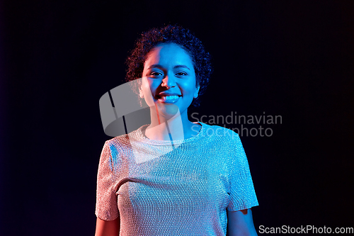 Image of african woman over neon lights on black background