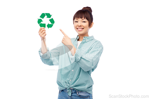 Image of smiling asian woman holding green recycling sign