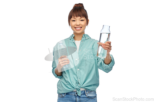 Image of asian woman with plastic and glass bottle of water