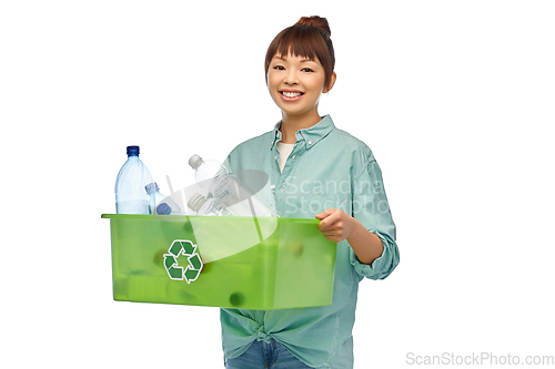 Image of smiling young asian woman sorting plastic waste