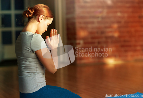 Image of woman meditating at yoga studio