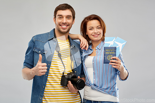 Image of couple with tickets, immunity passport and camera