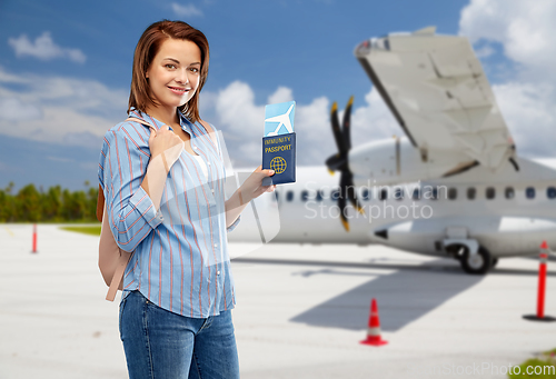 Image of happy woman with air ticket and immunity passport