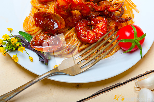 Image of Italian seafood spaghetti pasta on red tomato sauce