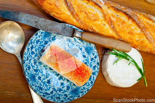 Image of French cheese and fresh  baguette on a wood cutter