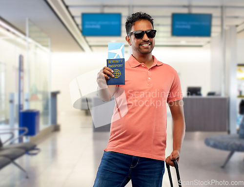Image of happy man with air ticket and immunity passport