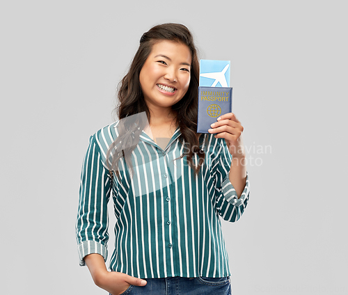 Image of asian woman with air ticket and immunity passport