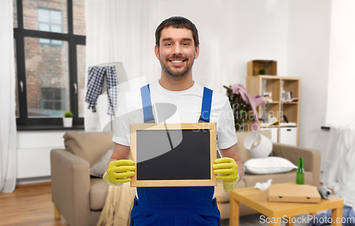 Image of male worker or cleaner with chalkboard at home