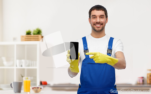 Image of male worker or cleaner with smartphone at kitchen