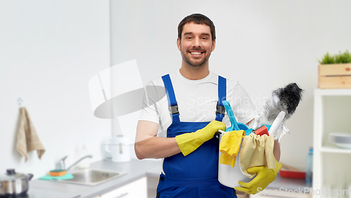 Image of male cleaner with cleaning supplies at kitchen