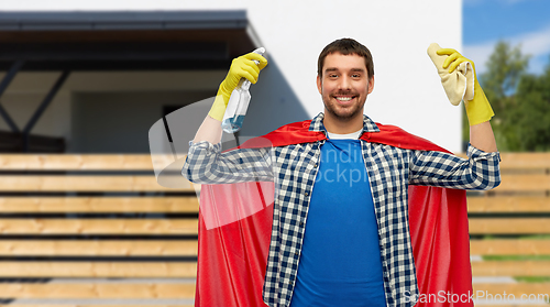 Image of smiling man in superhero cape with rag and cleaner