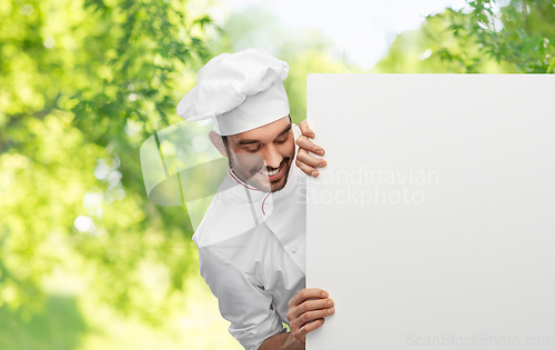 Image of happy smiling male chef with big white board