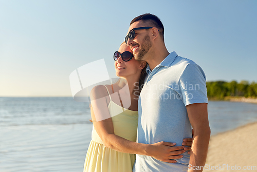 Image of happy couple hugging on summer beach