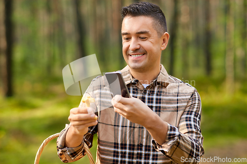 Image of man using smartphone to identify mushroom