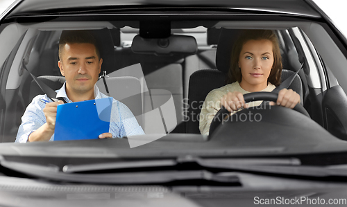 Image of car driving school instructor and young driver