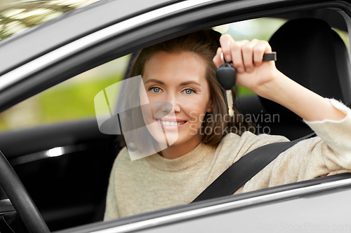 Image of woman or female driver with car key in city