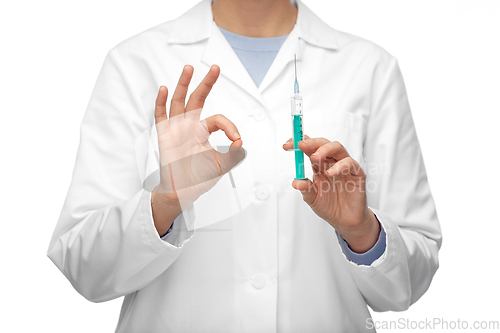 Image of close up of doctor with syringe showing ok gesture