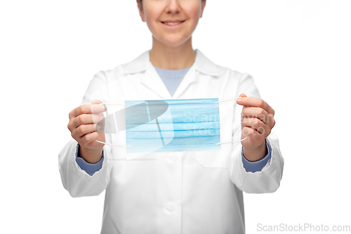 Image of female doctor showing medical mask