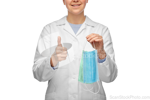 Image of smiling doctor with two masks showing thumbs up