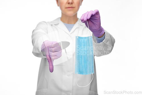 Image of female doctor with mask showing thumbs down