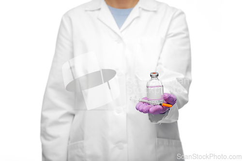 Image of close up of doctor with medicine and syringe