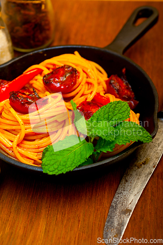 Image of italian spaghetti pasta and tomato with mint leaves