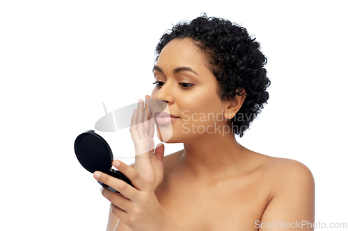 Image of african american woman looking to mirror