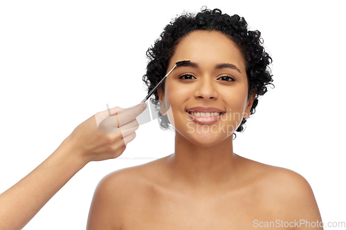 Image of happy woman and hand of make up artist with brush