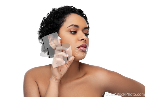 Image of young african american woman with moisturizer