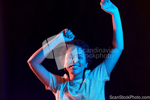 Image of african american woman dancing over neon lights