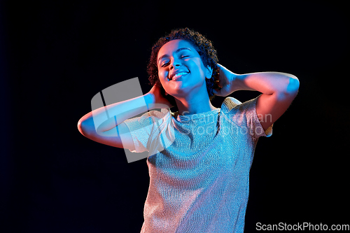 Image of african american woman dancing over neon lights