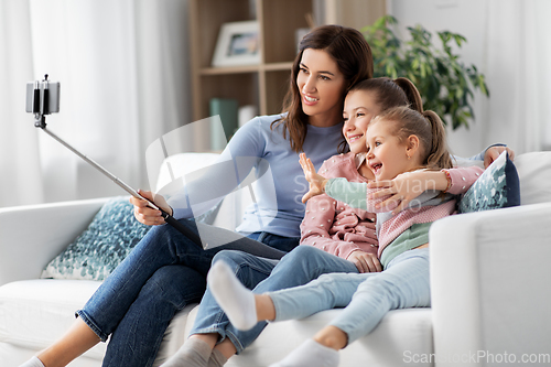 Image of happy family taking selfie by smartphone at home