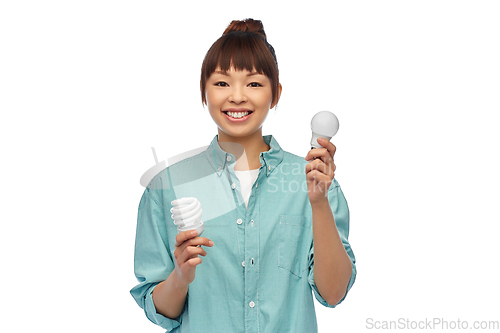 Image of asian woman holding energy saving lighting bulb