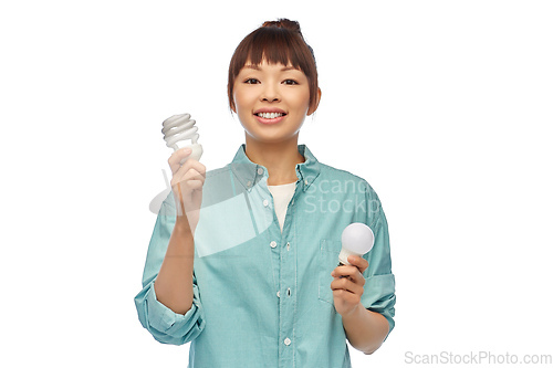 Image of asian woman holding energy saving lighting bulb