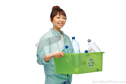 Image of smiling young asian woman sorting plastic waste