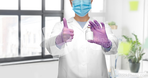 Image of close up of doctor with medicine showing thumbs up