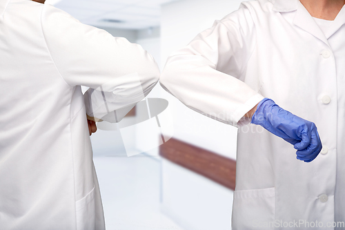 Image of close up of doctors make elbow bump gesture