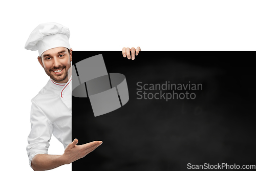 Image of happy smiling male chef with big black chalkboard