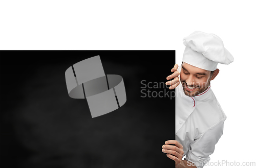 Image of happy smiling male chef with big black chalkboard