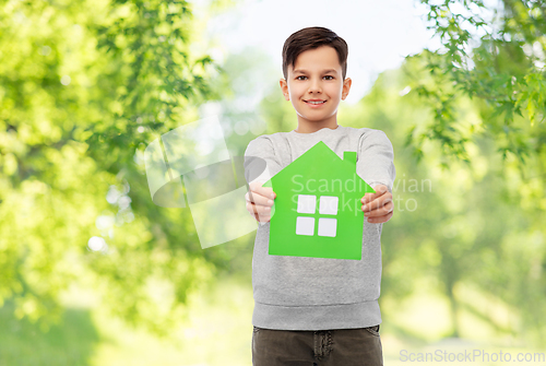 Image of smiling boy holding green house icon