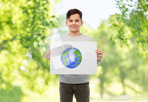 Image of smiling boy holding drawing of earth planet
