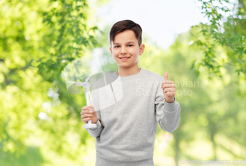 Image of smiling boy with toy wind turbine