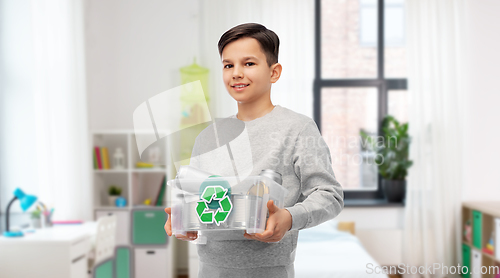 Image of smiling boy sorting metallic waste at home