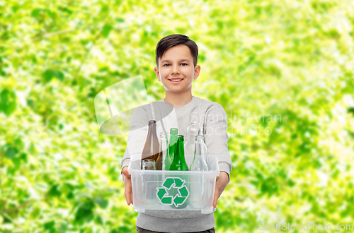 Image of smiling boy sorting glass waste